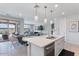 A stylish kitchen features a large island with seating, modern appliances, and an open layout to the living spaces at 32567 N 133Rd Ave, Peoria, AZ 85383