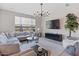 Cozy living room featuring a modern chandelier, comfortable seating, and a stylish entertainment center at 32567 N 133Rd Ave, Peoria, AZ 85383