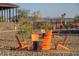 Outdoor seating area with Adirondack chairs, offering a relaxing space to enjoy the mountain views and American flag at 32567 N 133Rd Ave, Peoria, AZ 85383