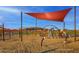 Community playground featuring slides and other equipment with sun shade and natural desert landscape at 32567 N 133Rd Ave, Peoria, AZ 85383