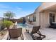 Sparkling pool with a waterfall feature, lounge chairs, and outdoor seating at 32567 N 133Rd Ave, Peoria, AZ 85383