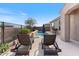 Sparkling pool with a waterfall feature, lounge chairs, and outdoor seating at 32567 N 133Rd Ave, Peoria, AZ 85383
