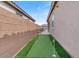 Putting green between the building and the privacy fence at 32567 N 133Rd Ave, Peoria, AZ 85383