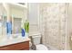 Bright bathroom with a vanity, toilet, and shower featuring a fun dog-themed curtain at 3381 E Canary Way, Chandler, AZ 85286
