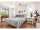 Inviting bedroom with a bed, stylish decor, and lots of natural light from large windows at 3381 E Canary Way, Chandler, AZ 85286
