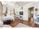 Bright bedroom featuring hardwood floors, a ceiling fan, and a comfortable bed with soft linens at 3381 E Canary Way, Chandler, AZ 85286
