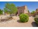 Attractive two-story home with a manicured front yard, complemented by desert-style landscaping and mature trees at 3381 E Canary Way, Chandler, AZ 85286