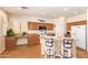 Bright kitchen with a spacious island, pendant lighting, modern appliances, and an adjacent breakfast bar at 3381 E Canary Way, Chandler, AZ 85286