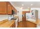 Functional kitchen with light wood cabinets, granite countertops, white appliances, and a breakfast bar at 3381 E Canary Way, Chandler, AZ 85286