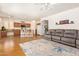 Open-concept living area showcasing a full kitchen, cozy seating, and warm wood flooring at 3381 E Canary Way, Chandler, AZ 85286