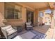 Comfortable covered patio with stylish seating and patterned rug, ideal for relaxing outdoors at 3381 E Canary Way, Chandler, AZ 85286