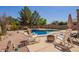 Beautiful backyard featuring a pristine pool, landscaping, and relaxing lounge area at 3381 E Canary Way, Chandler, AZ 85286