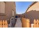 Narrow side yard with practical access, featuring a utility area and a view of the neighborhood at 3381 E Canary Way, Chandler, AZ 85286