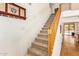 Carpeted staircase with wood railing leads to a bright, open living area with pool access at 3381 E Canary Way, Chandler, AZ 85286