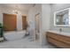 Bright bathroom with a freestanding tub, woven shades, and floating vanity at 3405 E Knox Rd, Phoenix, AZ 85044