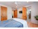 Bedroom with wood floors, ceiling fan, and access to bathroom at 3405 E Knox Rd, Phoenix, AZ 85044