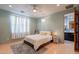 Cozy bedroom with light blue walls, white bedding, and ensuite bathroom at 3405 E Knox Rd, Phoenix, AZ 85044