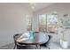 Elegant dining room features a round wood table, grey chairs, and bright natural light at 3405 E Knox Rd, Phoenix, AZ 85044