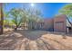 Exterior shot of home with desert landscaping, including backyard and covered patio at 3405 E Knox Rd, Phoenix, AZ 85044