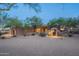 Stunning exterior of this home, featuring desert landscaping, mature trees, and warm lighting at 3405 E Knox Rd, Phoenix, AZ 85044