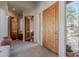 Bright foyer with tile flooring, tall windows, wooden doors, and arched doorway at 3405 E Knox Rd, Phoenix, AZ 85044