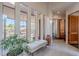 Bright foyer with tile flooring, tall windows, bench, and arched doorway at 3405 E Knox Rd, Phoenix, AZ 85044