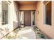 Inviting entryway with wood front door, sidelights, and desert-themed landscaping at 3405 E Knox Rd, Phoenix, AZ 85044