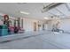 Well-lit, three-car garage with built-in cabinets, water heater, and a clean, epoxy-coated concrete floor at 3405 E Knox Rd, Phoenix, AZ 85044