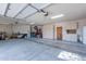 Spacious three-car garage featuring ample storage cabinets, a water heater, and an epoxy-coated floor at 3405 E Knox Rd, Phoenix, AZ 85044