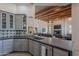 Stylish kitchen featuring gray cabinetry, modern countertops, and an open floor plan into the living area at 3405 E Knox Rd, Phoenix, AZ 85044