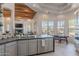 Modern kitchen with stainless steel appliances, gray cabinetry, and an eat-in dining area at 3405 E Knox Rd, Phoenix, AZ 85044