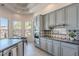 Bright kitchen features gray cabinetry, updated appliances, and a geometric backsplash at 3405 E Knox Rd, Phoenix, AZ 85044
