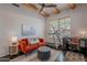 Cozy living room featuring exposed beam ceiling, comfortable seating, and a view of the outdoors at 3405 E Knox Rd, Phoenix, AZ 85044