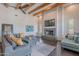 Spacious living room featuring a stone fireplace, large grey sectional, and wood beam ceilings at 3405 E Knox Rd, Phoenix, AZ 85044