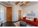 Comfortable living space features dark wood floors, exposed beam ceiling, and natural light at 3405 E Knox Rd, Phoenix, AZ 85044