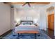 Comfortable primary bedroom features a king bed, wood beam ceilings, and cozy decor at 3405 E Knox Rd, Phoenix, AZ 85044