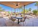 Relaxing covered patio features a dining table and beautiful backyard views at 3405 E Knox Rd, Phoenix, AZ 85044
