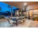 Inviting covered patio boasts ceiling fan and dining area, ideal for outdoor entertaining at 3405 E Knox Rd, Phoenix, AZ 85044