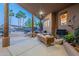 Inviting covered patio featuring comfortable seating and views of the lush backyard at 3405 E Knox Rd, Phoenix, AZ 85044