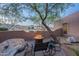 Relaxing outdoor patio area featuring a fire pit, comfortable seating, and desert views at 3405 E Knox Rd, Phoenix, AZ 85044