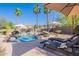 Beautiful backyard view with lounge chairs overlooking the pristine pool and tropical landscaping at 3405 E Knox Rd, Phoenix, AZ 85044