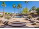 Gorgeous backyard showcasing a serene pool, complemented by lush landscaping and palm trees at 3405 E Knox Rd, Phoenix, AZ 85044