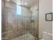 Glass-enclosed shower with neutral tile and mosaic accents at 3405 E Knox Rd, Phoenix, AZ 85044