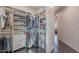 Organized walk-in closet with shelves, drawers, and hanging rods at 3405 E Knox Rd, Phoenix, AZ 85044