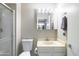 Compact bathroom features a toilet and vanity sink combination with a shower over the toilet at 3821 W Woodridge Dr, Glendale, AZ 85308