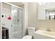 Compact bathroom features a toilet and vanity sink combination and a shower with sliding glass doors at 3821 W Woodridge Dr, Glendale, AZ 85308