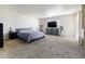 Spacious primary bedroom with carpet, ensuite bathroom, and ample space for a home gym setup at 3821 W Woodridge Dr, Glendale, AZ 85308