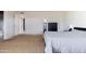 Light and airy bedroom with neutral walls and carpeted flooring, with attached bathroom at 3821 W Woodridge Dr, Glendale, AZ 85308