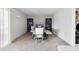 Dining room with bookshelves, carpet and a modern dining table set at 3821 W Woodridge Dr, Glendale, AZ 85308