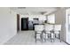 Updated kitchen with bar seating, tile backsplash, and stainless steel appliances at 3821 W Woodridge Dr, Glendale, AZ 85308